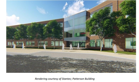 Exterior view of the modernized Patterson High School building, a multi-story brick structure with large windows, showing the main entrance and surrounding landscaping.