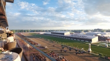 A vibrant horse racing event at Pimlico Race Course, with several horses competing on the track. The grandstand is filled with spectators, and tables with food overlook the race. The sky is partly cloudy, suggesting a pleasant day.