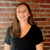 Professional headshot of Jill Novak of the Maryland Stadium Authority, smiling while posed in the Warehouse at Camden Yards